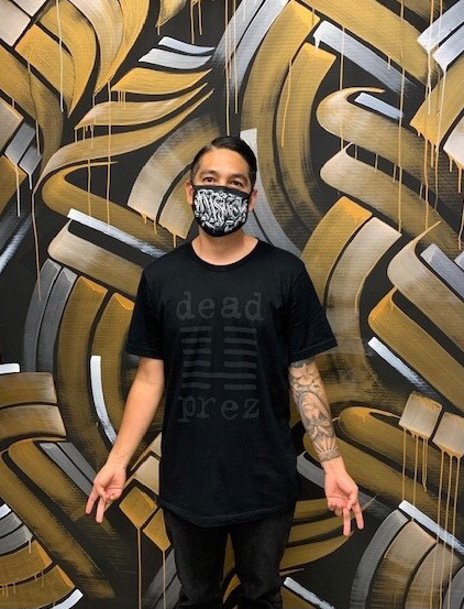 Zak Perez in front of his mural in Newport Beach