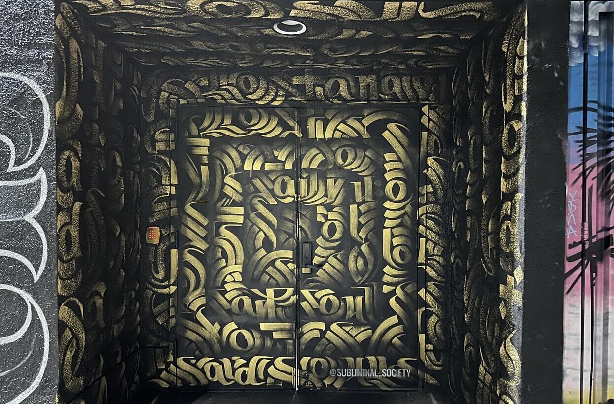 Black and gold calligraffiti street art