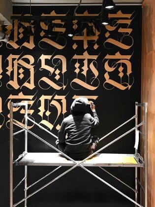 Cryptik painting a mural in Seoul Korea