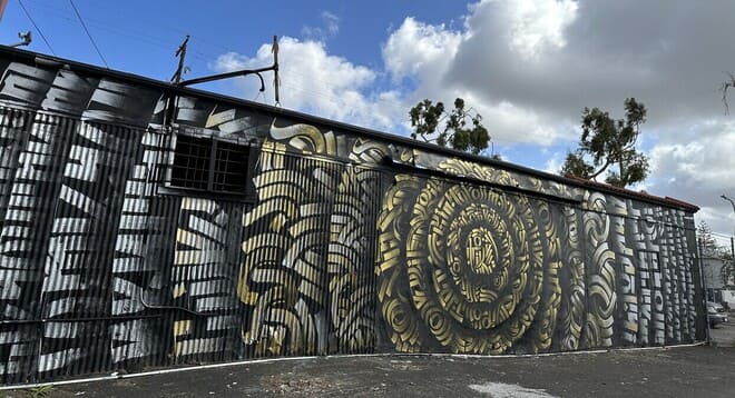 Mandala graffiti mural standing at 42 feet wide and 12 feet tall by Zak Perez