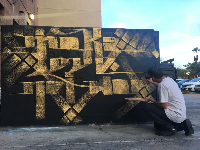 Zak Perez painting a mural at GCS in Downtown Santa Ana