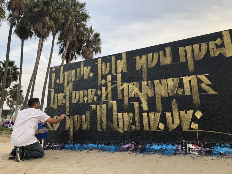 Venice Beach mural in black and gold that says the words of John 14:29 by Zak Perez