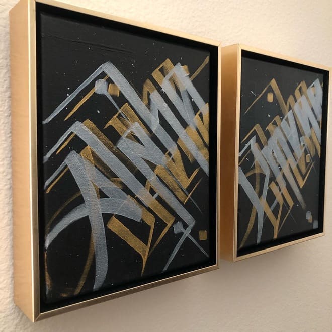 Calligraffiti canvas diptych that says Alpha and Omega in custom, gold floating frames