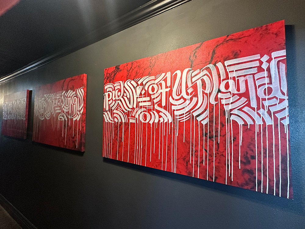 Canvas art at Kings Brewing with red canvas and light gray lettering
