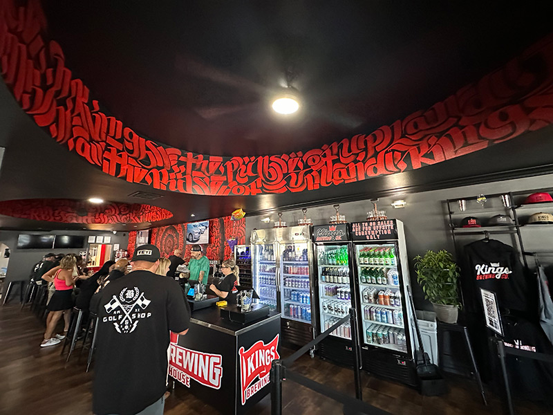Kings Brewing interior view showing ceiling mural and customers
